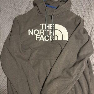 dark grey north face hoodie with white lettering